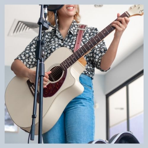 Worship Ministry. Woman playing guitar.